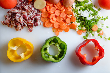 Spring vegetables and bacon on the kitchen table.Healthy foods are on the table. Homemade food preparation.