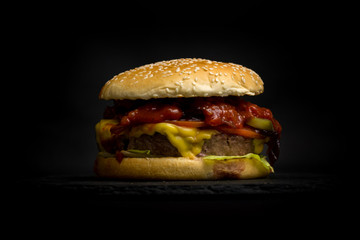 Close-up of delicious fresh  burger  on a dark background. Hambu