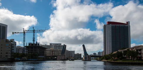 Draw bridge opening to let crane on barge go underneath