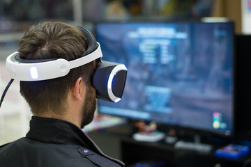 man in VR headset who enjoyng game. Virtual reality. man in VR headset with joysticks