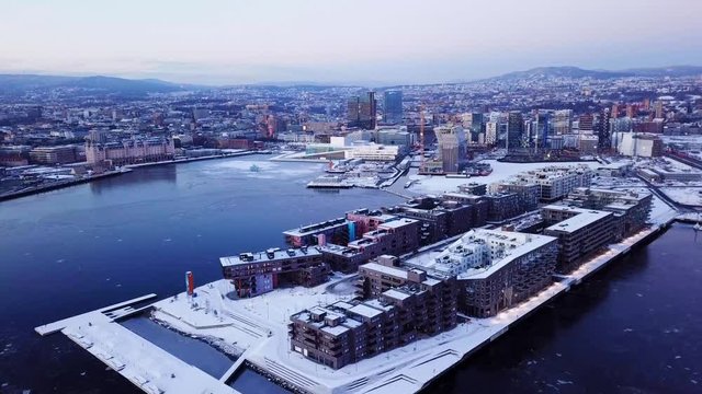 Aerial sliding shot along houses in Sorenga area at sunset of the new Munch museum Lambda in Oslo, Norway