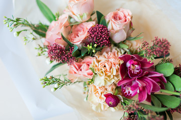 Close-up beautiful luxury bouquet of mixed flowers in glass vases. Bouquet of roses, carnations and orchids.