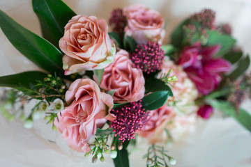 Close-up beautiful luxury bouquet of mixed flowers in glass vases. Bouquet of roses, carnations and orchids.