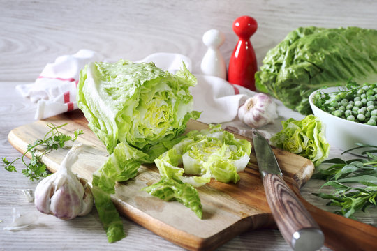 Healthy eating: lettuce, garlic, green peas and tarragon on cutting board