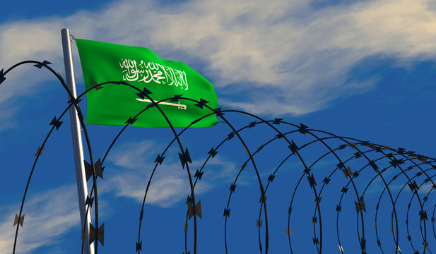 3D illustration of a Saudi Arabian flag waving on a flagpole with razor wire in the foreground; depicting security and barriers between nations. 