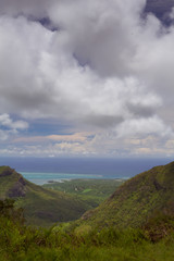 landscape: view of mountains covered with rainforest with Indian Ocean in the distance. Mauritius island