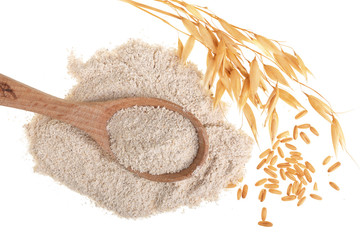 oat spike with flour in wooden spoon isolated on white background. Top view. Flat lay