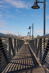 pedestrian bridge crossing water near dam at lake