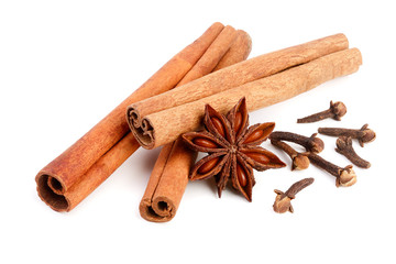 Cinnamon sticks with star anise and clove isolated on white background. Top view