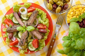 Beef salad on the plate. Grilled beef meat with tasty selection of vegetables.
