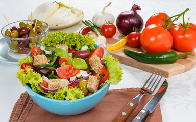 Fresh vitaminic green salad with bread cubes and tasty selection of vegetables.