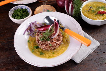 Plate of rice and red cereals with pumpkin and herbs