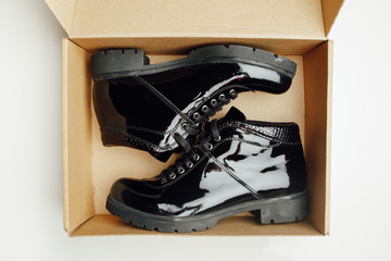 black varnished patent leather shoes in cardboard box