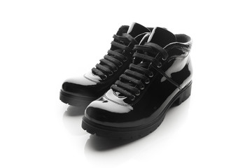 black varnished patent leather shoes isolated on white
