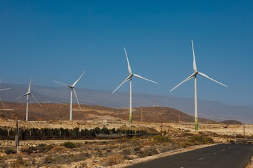 Fototapeta premium electric wind turbines farm, blue sky background