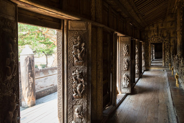 Decorated open doors and corridor at the wooden Shwenandaw Monastery (also known as Golden Palace Monastery) in Mandalay, Myanmar (Burma).