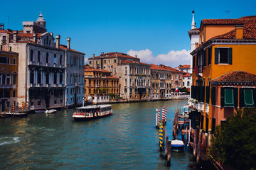 Beautiful panoramic view over the famous Grand canal in Venice, surrounded by old and romantic architecture illuminated by sun, in Italy. Natural colors