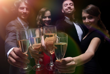 Cheerful people celebrating a sucess with Champagne