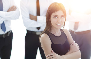 young employee of the company, standing in front of their colleagues.