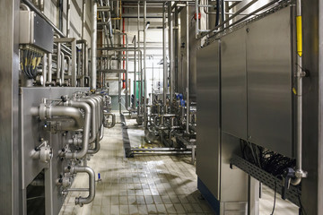 Modern brewery factory interior.Steel tanks or vats for filtration beer, pipe lines and other equipment tool in plant workshop