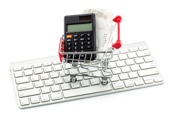 Shopping Trolley With Receipts And Calculator, keyboard over white background