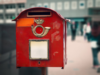 red worn-out mailbox on the street