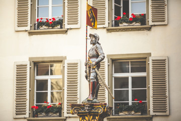 Streets of Bern with a statue and a flag