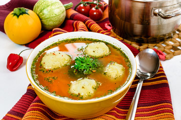 Vegetable soup with dumplings in the bowl.