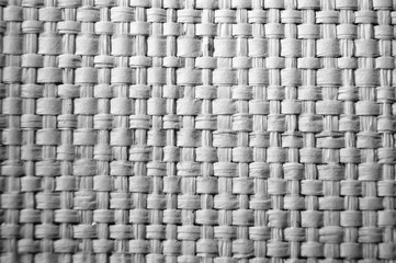 Fototapeta premium Close-up of gray plastic weave as woven background texture or pattern in black and white