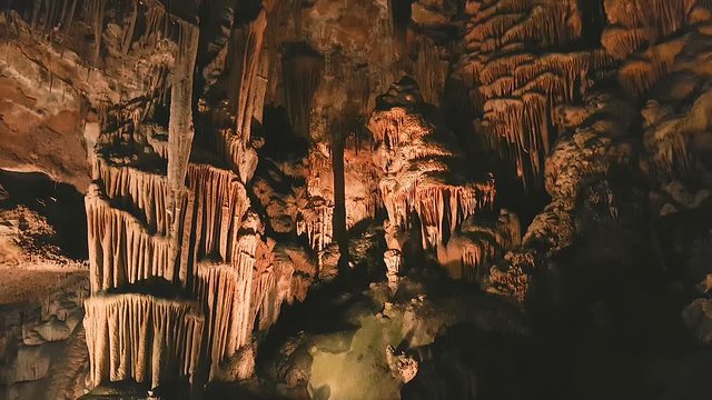 Tilt down ancient rock formation drapes on the wall of Saeva Cave, Bulgaria