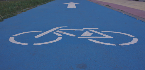 Bicycle. White bicycle sign on a blue road. Road sign.