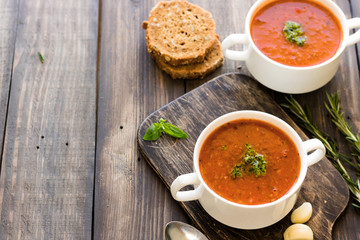Thick Italian soup minestrone on a wooden table