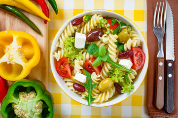 Pasta salad with tomato,arugula, cucumber, peppers,hot peppers, black and green olives, and cheese...