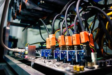 Fototapeta premium local mini mining farm works both for cryptocurrency and as heater in cafe. Low light image.