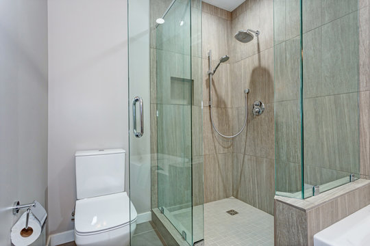 Stylish bathroom interior with glass walk in shower