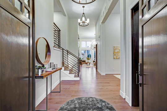 Chic entrance foyer with high ceiling and white walls.