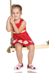 Little girl swinging on a swing