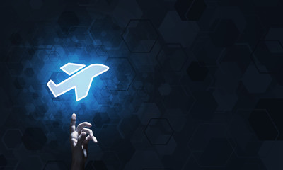 Airplane glowing icon touched with finger as online booking concept