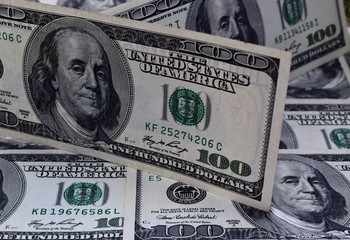 Hundred dollar bill on the background of dollars