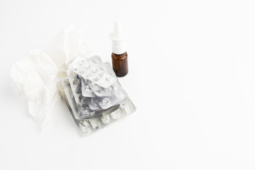 Pharmaceutical concept with empty blisters, spray for nose and paper tissue