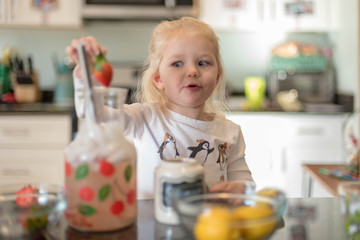 Little girl making lemonade