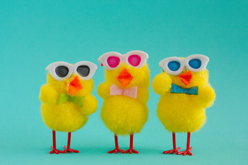 Three Groovy Chicks wearing sunglasses on a Aqua Background.