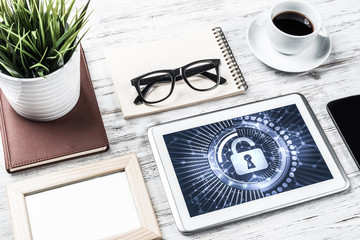 Web security and technology concept with tablet pc on wooden tab