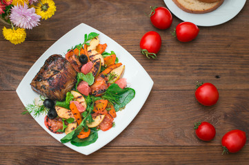 Beef steak with grilled vegetables, spinach and grapefruit with apples. Wooden rustic background. Top view