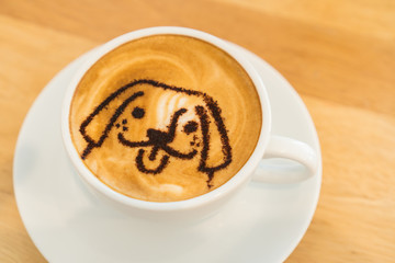 A Cup of hot latte art coffee on wooden table