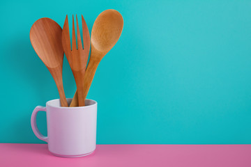 wooden kitchen utensils in white mug