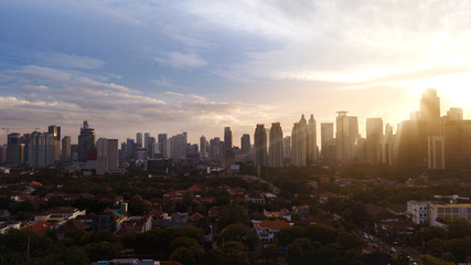 Fototapeta premium Skyscrapers and residential under light of sunset