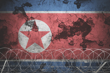 North korea national flag with grunge background and barb wire