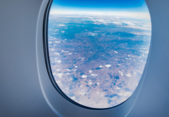 airplane window when flying see through at cloud and blue sky,Transportation,Travel concept