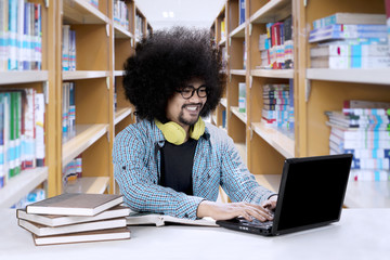 Afro student studying in the library